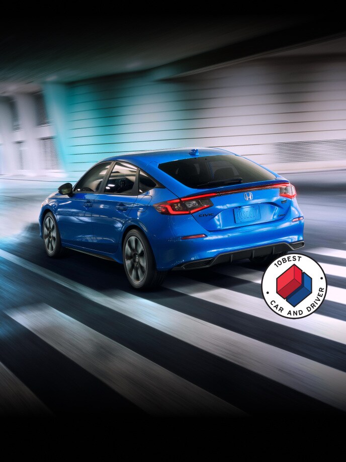 2026 Honda Civic Hatchback tSport Touring Hybrid in Boost Blue Pearl back driving through a tunnel (Compact Hatchback).