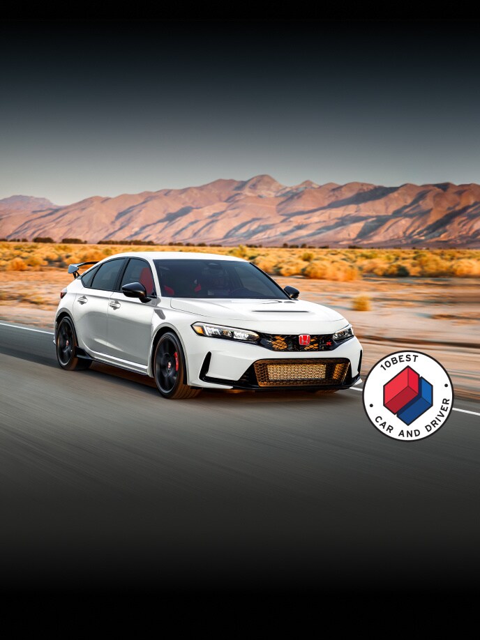 2026 Honda Civic Type R in Championship White front 3/4 driving in a road with overlapping Car and Driver 10Best logo (High-Performance Hatchback).
