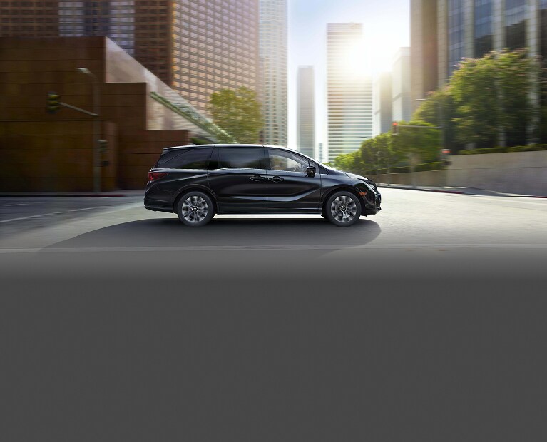 2026 Honda Odyssey Elite driving through city environment.