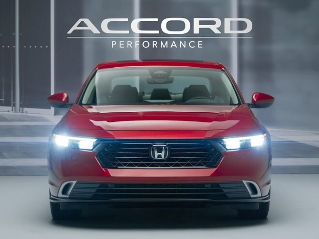Rear shot of 2026 Honda Accord front view in Radiant Red Metallic showing LED lights on.