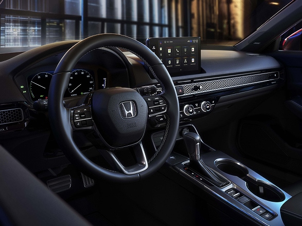 2026 Honda Civic Hatchback Sport Touring Hybrid interior dashboard, steering wheel, and digital infotainment screen (Compact Hatchback).