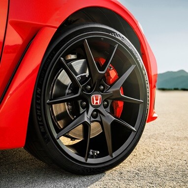 Tire detail of a 2026 Honda Civic Type R in Rallye Red