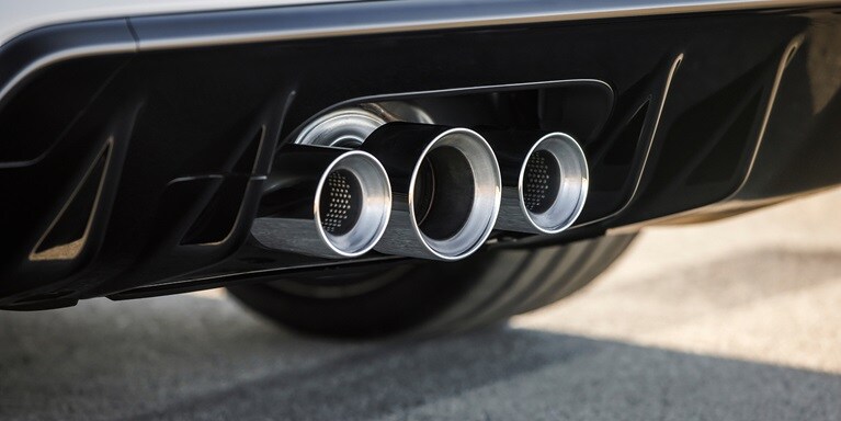 Detail of the triple-outlet exhaust of a 2026 Honda Civic Type R in Championship White