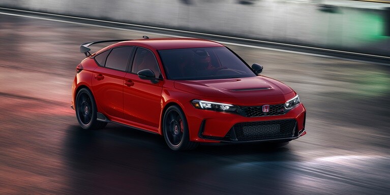 2026 Honda Civic Type R in Rallye red driving at night