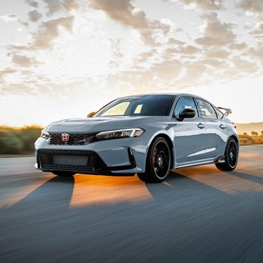 2026 Honda Civic Type R in Championship White driving on a highway
