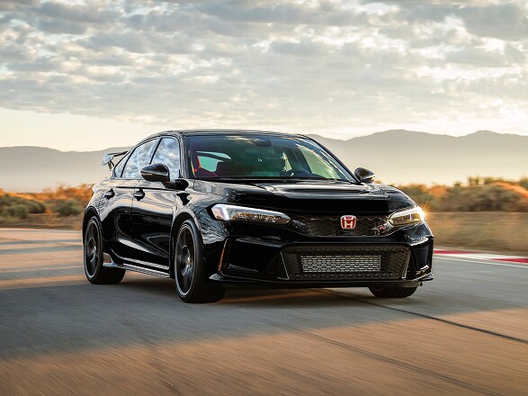 2026 Honda Civic Type R in Crystal Black Pearl driving on a race track