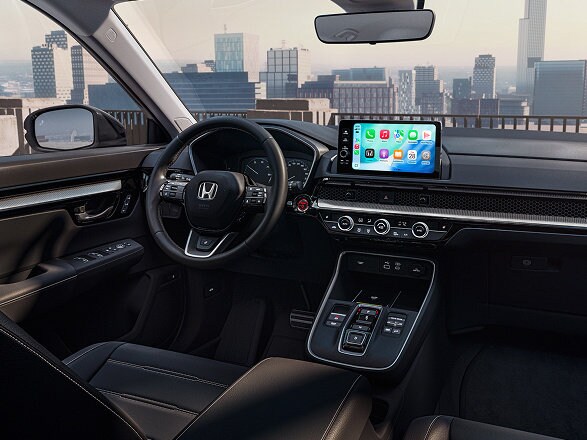 Interior shot of a 2026 CR-V e:FCEV in front of a City View.